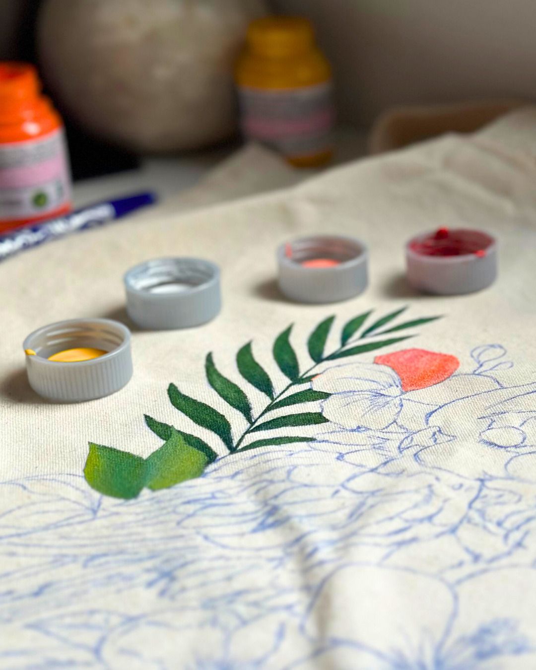 Artist hand-painting a traditional Indian motif onto fabric